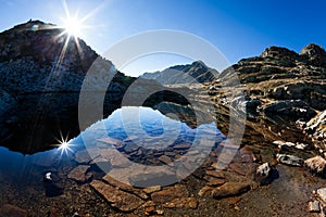 Small mountain lake in a sunny autumn day