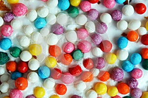 Small multi-colored Easter eggs on the kulich, festively decorated with colorful painted eggs paint, background