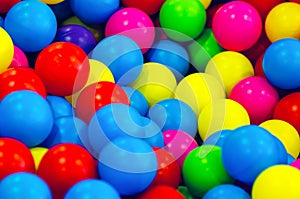 Small multi colored plastic baby balls, background texture