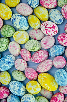 Small multicolored Easter eggs. Spring background. View from above. Flat lay