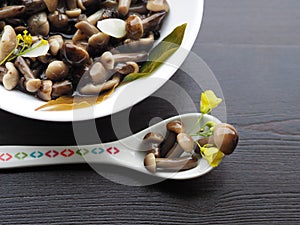 Small mushrooms in a spoon close-up.