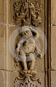 small naked cherub with floral ornamentation