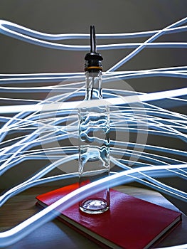 Small narrow bottle with bartender pourer on table