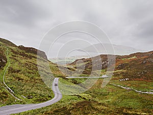 Small narrow road in a stunning mountain area. Mamore gap, county Donegal, Ireland. Amazing drive with rough wild nature scenery.