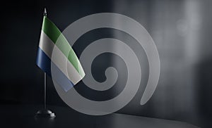 Small national flag of the Sierra Leone on a black background