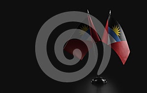 Small national flags of the Antigua and Barbuda on a black background