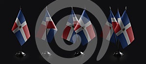 Small national flags of the Dominicana on a black background