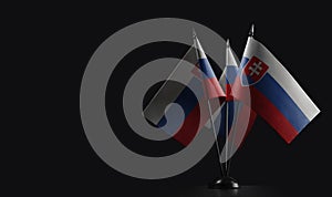 Small national flags of the Slovakia on a black background