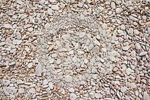 Small naturally polished white rock pebbles background. White pastel round stones on beach. Vacation, walking on the