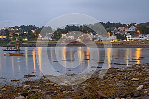 Norwegian village at dusk with reflections on water