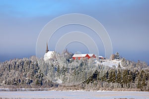 Small Norwegian village on the shores of a lake. Traditional church in the village.