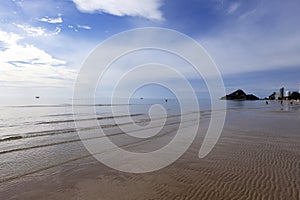 Small ocean sea waves on sandy beach with sunrise sunset. Background landscape picture of dusk or dawn at the Atlantic ocean