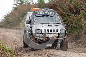 Small off-road car moving by dirt road