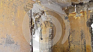 Small old and abandoned damaged house roof with tiles demolished by the earthquake destruction closeup, demolished house concept