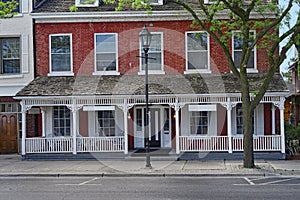 Old  apartment building or hotel with full width porch photo