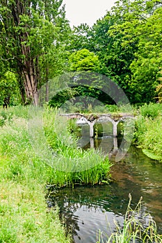 Small old arched bridge in Morden Hall Park Park