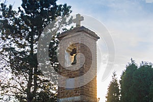 Small old church tower in the sunlight with sky in background