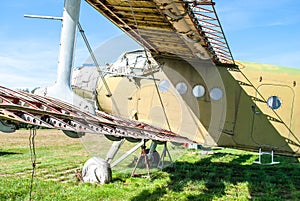 Small old plane standing in summer green field