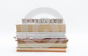 Small old stack of books with reading glasses and message word at the top, isolated on white background