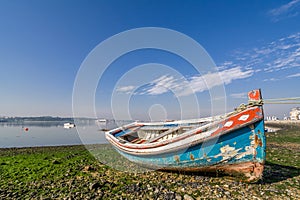 Small, old traditional boat in Seixal bay