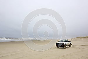 Small Old White Truck on Beach in Winter