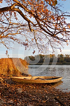 Small old wooden boat on the autumn beach