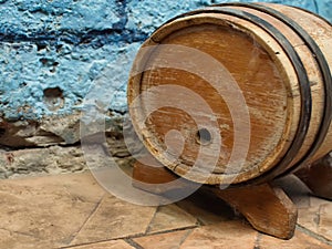 Small old wooden wine barrel on a wooden stand.