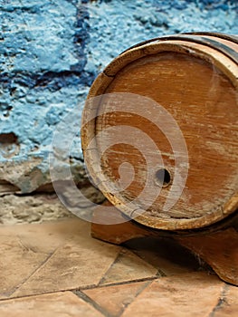 Small old wooden wine barrel on a wooden stand.