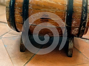 Small old wooden wine barrel on a wooden stand.