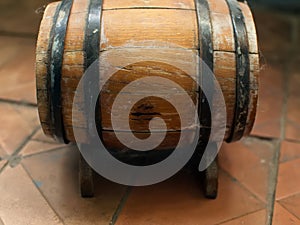 Small old wooden wine barrel on a wooden stand.