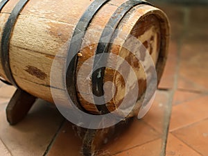 Small old wooden wine barrel on a wooden stand.