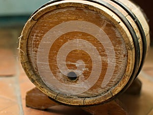 Small old wooden wine barrel on a wooden stand.