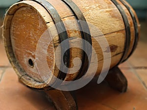 Small old wooden wine barrel on a wooden stand.