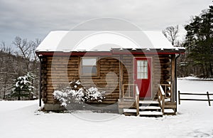 Small one roomed log cabin in snow in winter