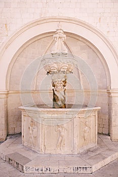 The small Onofrio fountain designed by the Italian architect Onofrio di Giordano della Cava at Stradun, the large street