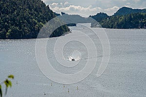 Small open boat cruising through a fjord..