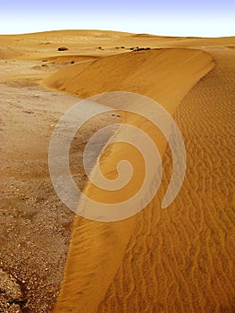 Small orange colored dunes of dry Namib desert in Namibia near Swakopmund, South Africa