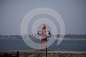 Small orange lighthouse on Esbjerg harbor in Denmark photo