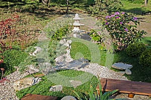 Small oriental garden for relaxing. Japanese stilb with pebble paths