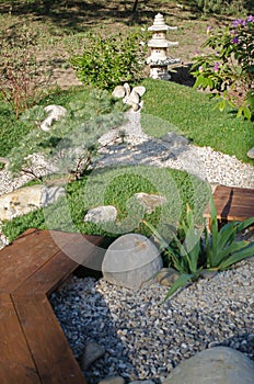 Small oriental garden for relaxing. Japanese stilb with pebble paths