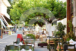 Small outdoor restaurants at the pedestrian area at center of Kalavryta town near the square and odontotos train station, Greece