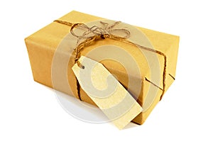 Small package with label tied with string, isolated on white