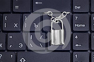 Small padlock with a chain on a laptop keyboard