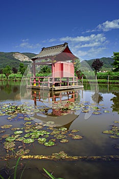 small pagoda in the middle of the lake photo