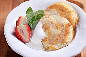 Small pancakes with cream and strawberry