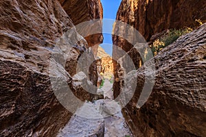 A small passage between the steep rocks at Little Petra in Siq a