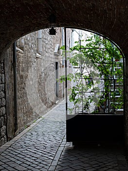 Small passage trough a narrow alley in the city of Cres