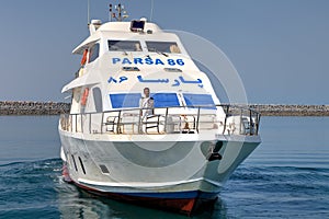 A small passenger ship departs from the pier, southern Iran.