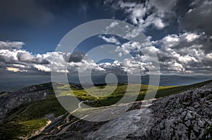 Small patch of snow in the summer in the middle of grassy meadow in rax plateau photo