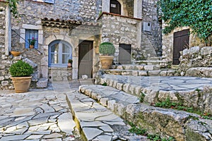 Small patio with flowers in the old village Gourdon
